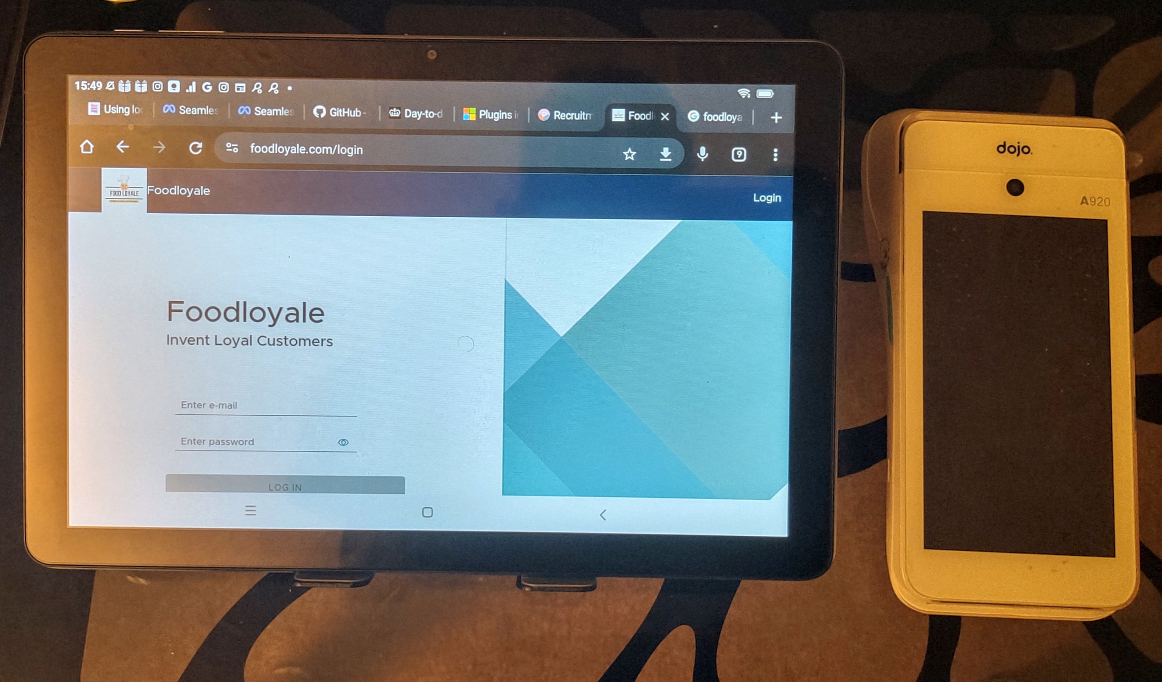 Foodloyale running on a tablet next to a Dojo card terminal